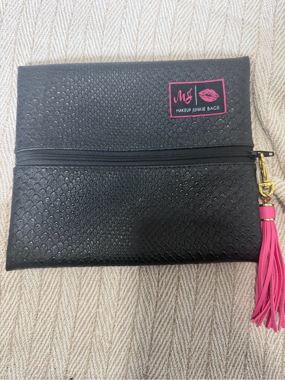 Black Cosmetic Pouch with Pink Tassel Accent